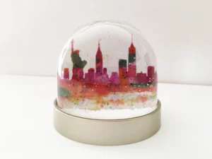 new york snow globe red splash, New York plastic snow globe, watercolour paintings of New York, Empire State B building, Statue of Liberty, New York skyline, Manhattan, New York artwork, New York painting, Louisa E. Taylor, Trump, USA